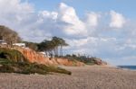 Beach And Cliffs In Quarteira Stock Photo