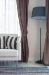 Black Lamp With Modern Sofa On Carpet Stock Photo