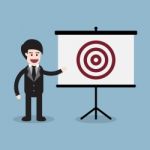 Businessman With Target Presentation Board Stock Photo