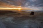 Photographer Taking A Sun Set Photograph On Hokitika Beach South Island New Zealand Stock Photo