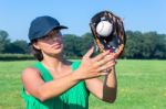 Woman With Glove And Cap Catching Baseball Stock Photo