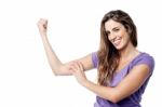 Strong Pretty Girl Showing Her Biceps Stock Photo