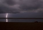 Surreal, Stormy Night Enlightened By Thunder On The Coastline In Stock Photo