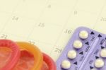 Pills And Condom On Carlendar Background With Soft Light Stock Photo