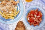 Turkey Steak With French Fries And Tomato Salad Stock Photo