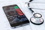 Business Concept. Financial Analysis, Smartphone And Stethoscope Stock Photo
