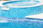 Swimming Pool With Waterfall Jet Stock Photo