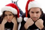 Close Up View Of Young Couple Wearing Christmas Hat And Looking At Camera Stock Photo