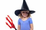 Pretty Girl In Witches Hat Holding Devils Pitchfork Stock Photo