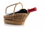 Red Wine Bottle in Bamboo Basket Stock Photo
