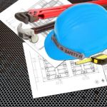 Blue Helmet Of Foreman Or Guest Constructor With Blueprints Stock Photo