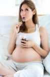 Gorgeous Pregnant Woman Eating Yogurt Stock Photo