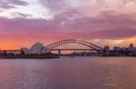 Opera House And Harbour Bridge In Sydney At Night, It Is Illuminated By Golden Lights .australia Stock Photo