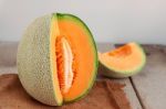 Melon Cut On Wooden Stock Photo