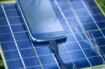 Charging Mobile Phone With Solar Charger Stock Photo