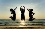 Young Girls Jumping at beach Stock Photo