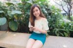 Portrait Of Thai Student University Beautiful Girl Using Her Smart Phone Stock Photo