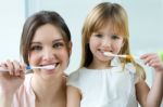 Mother And Daughter Brushing Teeth In The Bathroom Stock Photo