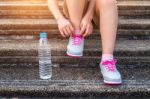 Young Woman Runner Tying Shoelaces. Exercise Concept Stock Photo