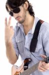 Young Guy Holding Guitar And Gesturing Stock Photo