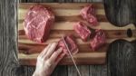 Cutting Angus Beef On The Wooden Table Top View Stock Photo