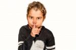 Girl Holding Index Finger Around The Mouth. A Gesture Of Silence . Closeup-isolated On White Background Stock Photo