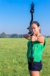 Woman Aiming With Bow And Arrow In Nature Stock Photo