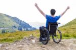Optimistic Handicapped Man Sitting On Wheelchair Stock Photo