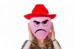Girl Holding Pink Balloon With Angry Face And Red Hat Stock Photo