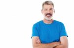 Casual Man Standing With His Arms Crossed Stock Photo