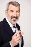 Happy Businessman With Cigar Stock Photo