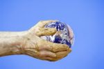 Earth In Hands Of Potter Stock Photo