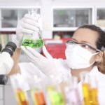 Chemist Holding Sample Of Liquid Stock Photo