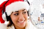 Smiling Young Girl Posing In Christmas Hat And Listening To Songs Stock Photo