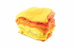 Pile Of Yellow And Orange Shade Cloths On White Background Stock Photo