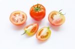 Tomato And Pieces Of Fresh Tomato Isolated On White Stock Photo