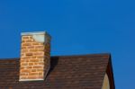 The Brick Chimney In Bright Sunlight A Deep Blue Sky Horizontal Stock Photo