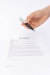 Hand Offering Pen For Signature Above Contract Paper Stock Photo
