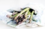 Bunch Of Fresh Asparagus In A Kitchen Cloth Stock Photo