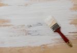 Used Paint Brush On Wooden Floor Background Stock Photo