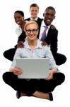 Smiling Business Team With Laptop Stock Photo