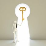 Businessman Keep Key Into A Gate Shaped Like A Keyhole Stock Photo