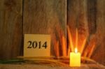 Still Life With 2014 Wrote On Notepad And Candle Light On Wooden Stock Photo