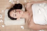 Attractive Woman Getting Flower Spa Treatment Stock Photo