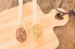 Spoon Of Flax Seed On Wooden Table Stock Photo