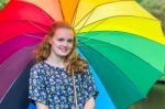 Teenage Girl Under Umbrella With Various Colors Stock Photo