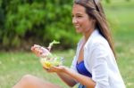 Beautiful Young Woman Holding Green Salad, Outdoors Stock Photo
