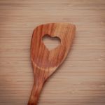 Wooden Cooking Utensils Border. Wooden Spatula With Heart Shape Stock Photo