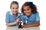 Kids In Uniform Playing With Microscope Stock Photo