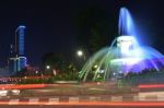 The Fountain At The City Intersection With The Building's Background Towering High Behind Stock Photo